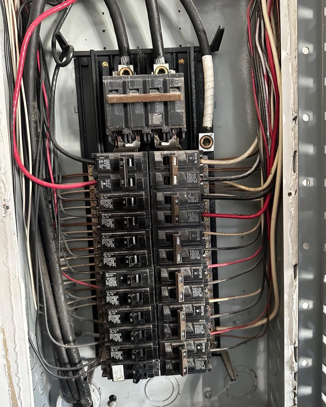 Parallel rows of EMT conduit entering an industrial breaker box