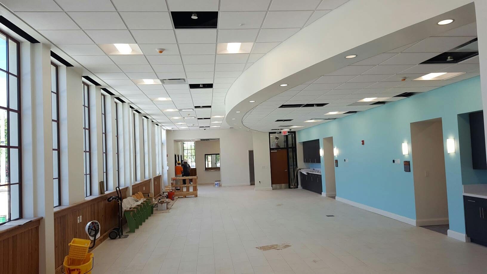 Electrician adjusting an architectural LED ceiling luminaire fixture