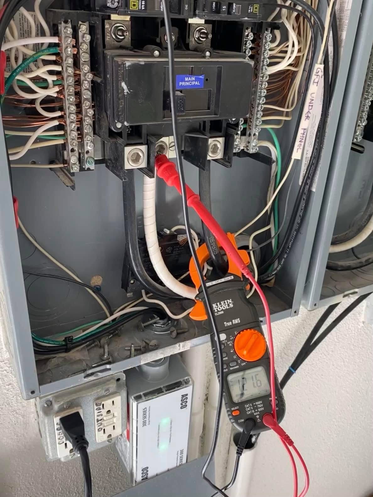 Technician repairing circuit breakers in an electrical service cabinet